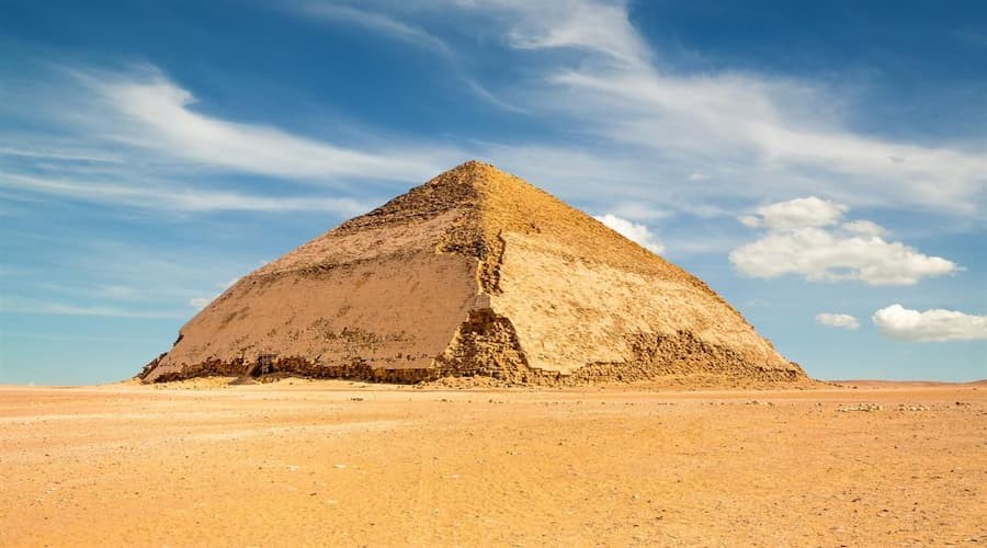 View of the Bent Pyramid in Dahshur with its distinctive angled shape in the desert
